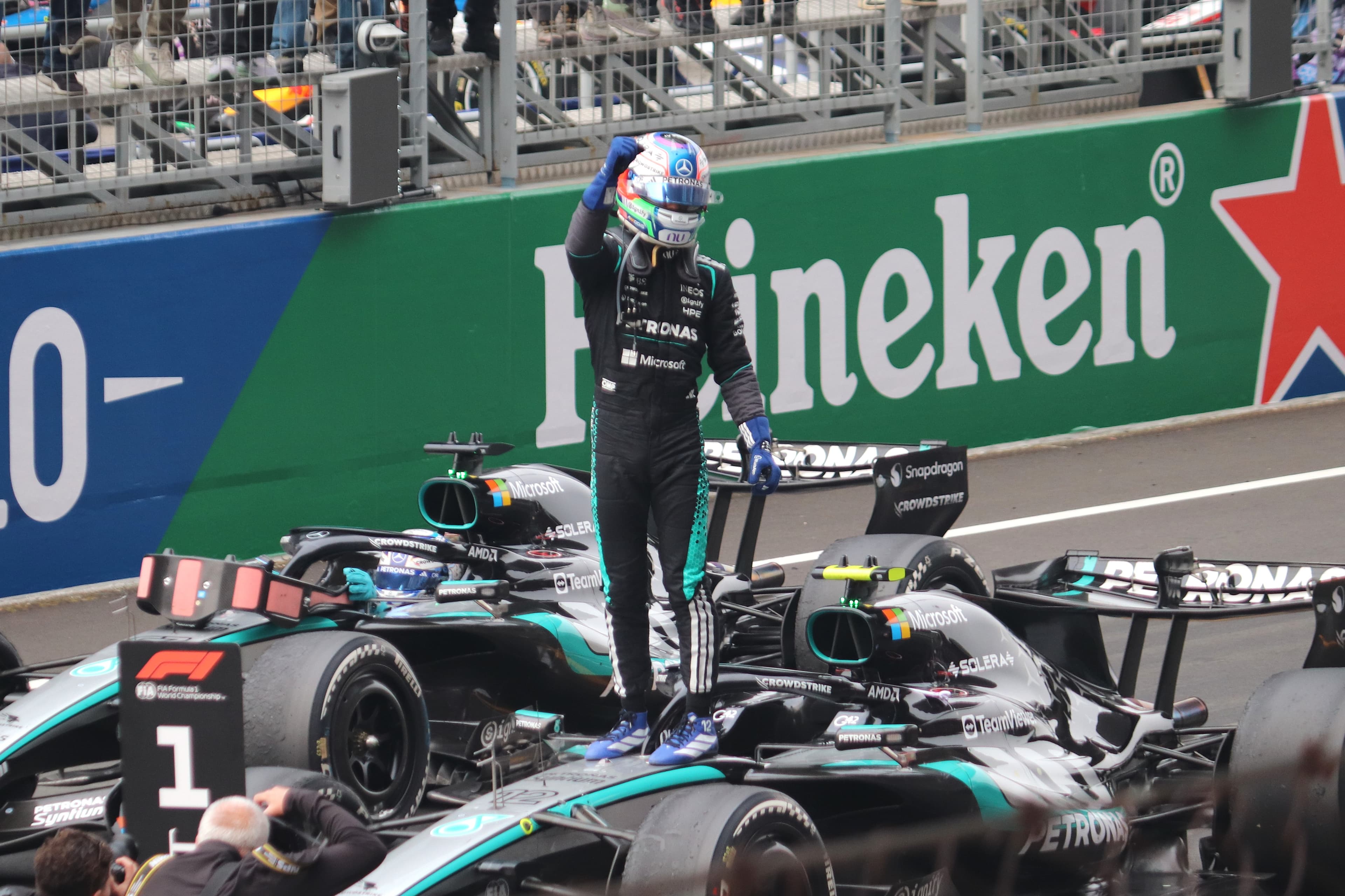 Kimi Antonelli celebrates beside his Mercedes after winning the 2026 Chinese Grand Prix