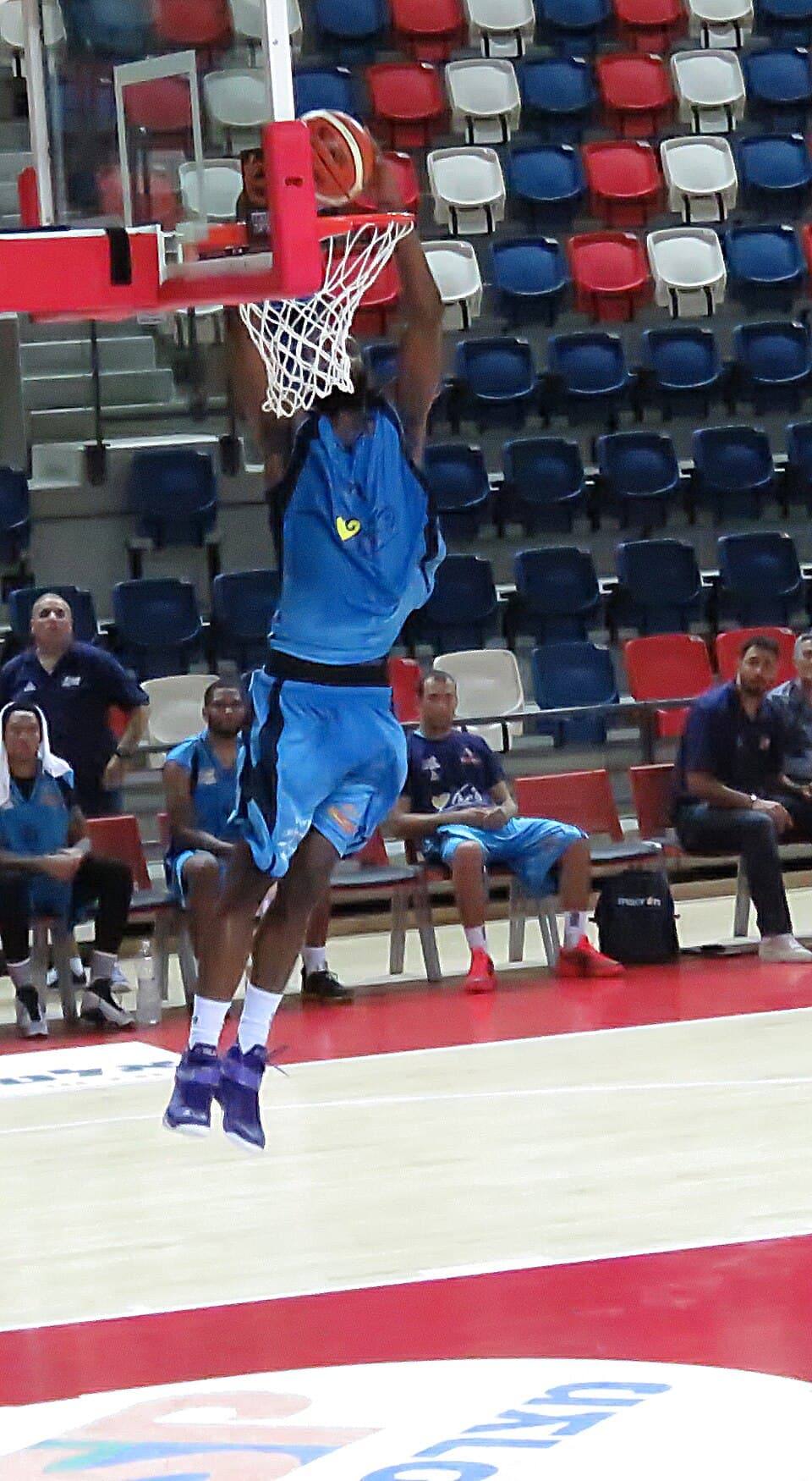A Hapoel Tel Aviv player dunks during a pre-season game
