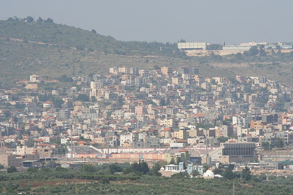 Doha Stadium and the city of Sakhnin