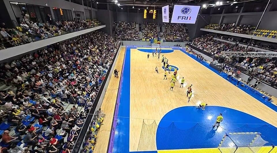 A capacity crowd watches a handball match at the Turda Arena in Romania