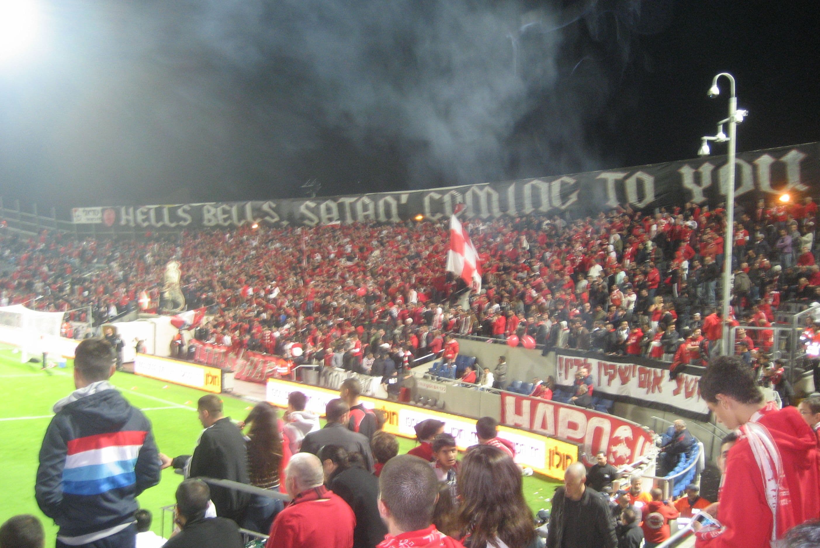 Hapoel Tel Aviv supporters fill a smoky stand before a Tel Aviv derby in 2012