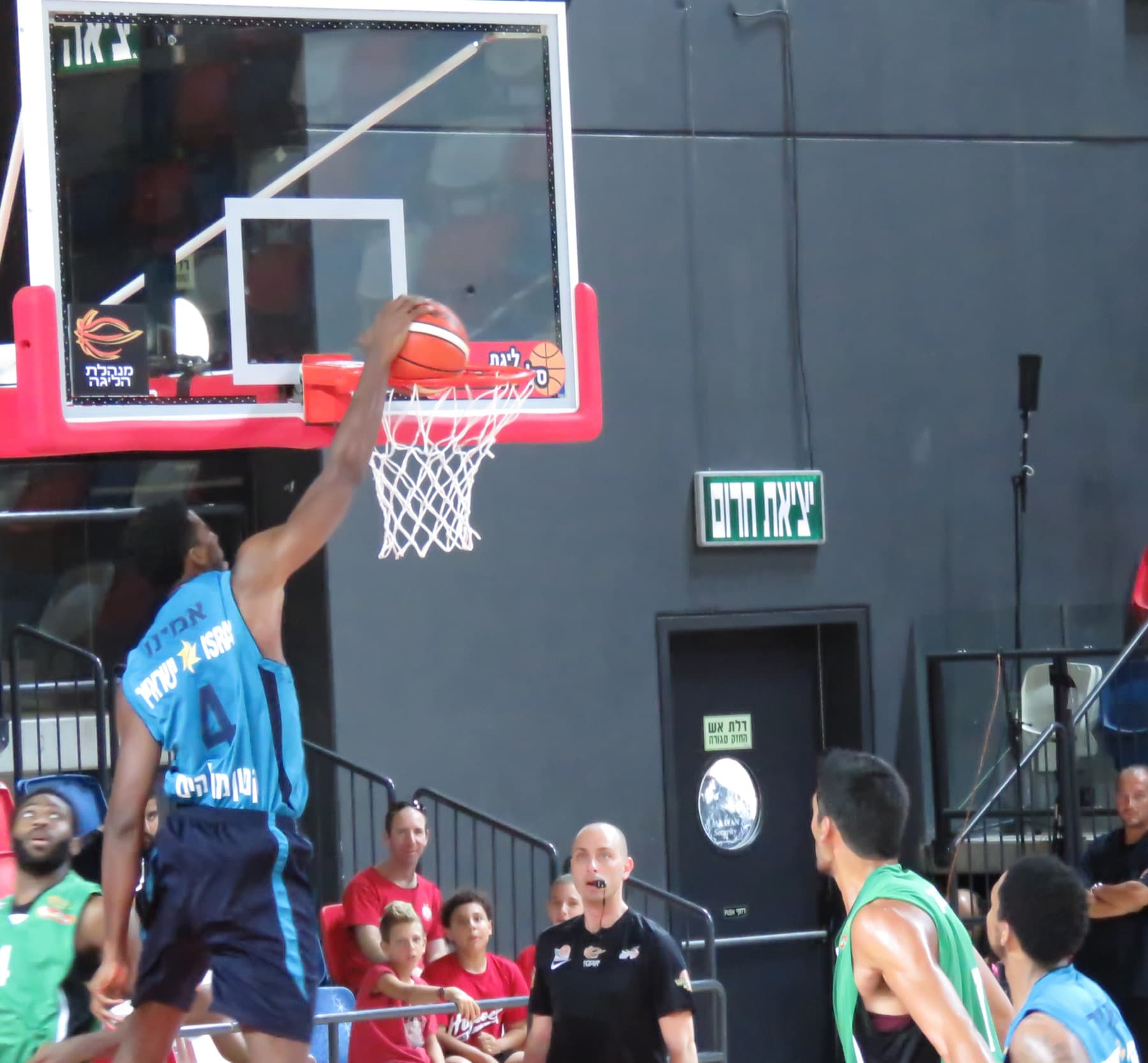 Hapoel Eilat forward Alade Aminu dunks during a match against Maccabi Haifa