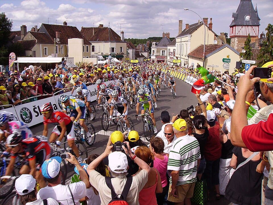 2009 Tour de France, stage 11. Riders begin the ascent of the last hill; they are 400 meters from the finish (as indicated on the two signs); Saint-Fargeau, Yonne, France