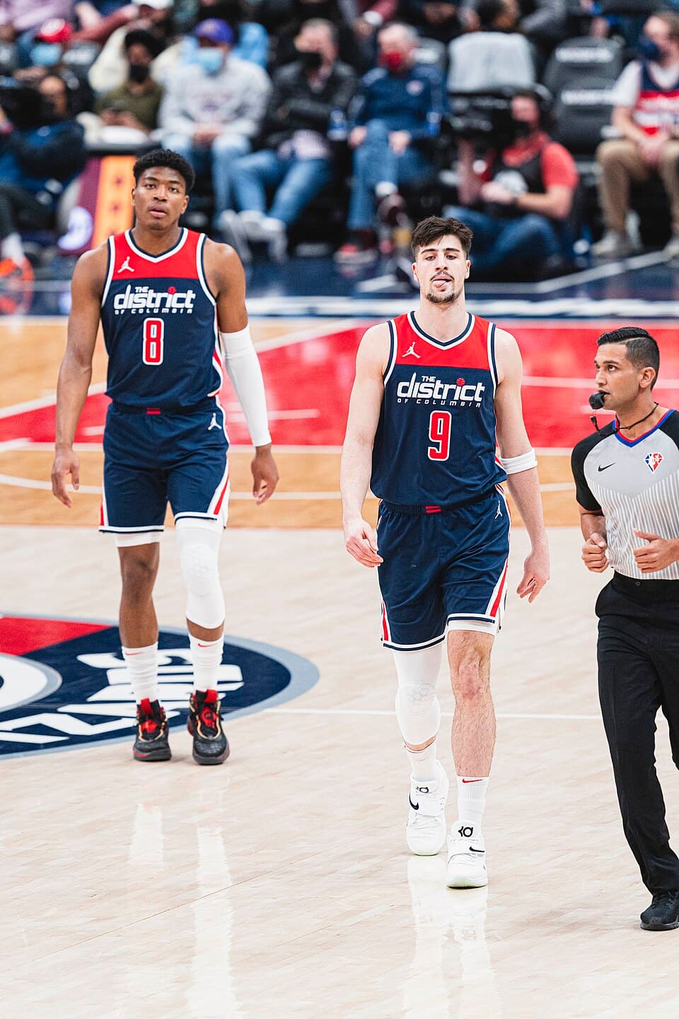 Deni Avdija walks upcourt alongside Wizards team-mate Rui Hachimura